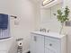 Bright bathroom featuring a white vanity with chrome fixtures, a white countertop and a decorative vase at 1010 E Redfield Rd, Tempe, AZ 85283