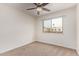 This bedroom has neutral carpet, a ceiling fan, a double-hung window, and white walls at 1010 E Redfield Rd, Tempe, AZ 85283