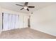 Bedroom featuring neutral carpet, ceiling fan, and closet with curtain at 1010 E Redfield Rd, Tempe, AZ 85283