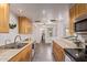 Galley kitchen with stainless appliances and generous counter space flows into dining area at 1010 E Redfield Rd, Tempe, AZ 85283