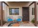 Front patio sitting area with two chairs, a table and a hello doormat at 1010 E Redfield Rd, Tempe, AZ 85283