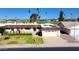 Charming home with a well-manicured lawn, two-car garage, and a view of the golf course at 10416 W Prairie Hills Cir, Sun City, AZ 85351