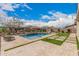 Beautiful backyard with a refreshing pool and green space perfect for entertaining at 10717 E Tarragon Ave, Mesa, AZ 85212