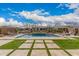 Expansive backyard with a pool, fire pit, and pavers perfect for outdoor living at 10717 E Tarragon Ave, Mesa, AZ 85212