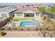 Aerial view of the backyard featuring a beautiful pool, outdoor seating, and an attached patio at 10717 E Tarragon Ave, Mesa, AZ 85212