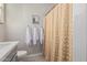 Cozy bathroom featuring a patterned shower curtain, soft white towels, and a cactus print at 10717 E Tarragon Ave, Mesa, AZ 85212