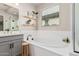 Modern bathroom featuring a soaking tub and window, designed for relaxation at 10717 E Tarragon Ave, Mesa, AZ 85212