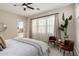 Serene bedroom featuring a ceiling fan and view of the backyard at 10717 E Tarragon Ave, Mesa, AZ 85212