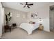 Calm bedroom with a neutral palette, ceiling fan, and seating area, creating a relaxing atmosphere at 10717 E Tarragon Ave, Mesa, AZ 85212