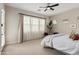 Bright bedroom featuring a ceiling fan and view of the backyard at 10717 E Tarragon Ave, Mesa, AZ 85212