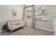 Bright Bedroom featuring a white crib, floating shelves, and natural light at 10717 E Tarragon Ave, Mesa, AZ 85212