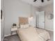 Bright, neutral bedroom features a pendant light, white nightstands, and woven headboard at 10717 E Tarragon Ave, Mesa, AZ 85212