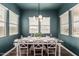 Dining room with large table, seating for six, chandelier, and multiple windows for great lighting at 10717 E Tarragon Ave, Mesa, AZ 85212