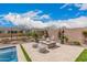 Contemporary outdoor living with a gas firepit, patio, and plush seating at 10717 E Tarragon Ave, Mesa, AZ 85212