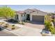 Charming single-story home featuring a well-manicured yard and a two-car garage at 10717 E Tarragon Ave, Mesa, AZ 85212