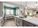 View of kitchen, dining area and living room, showing kitchen island, seating, and appliances at 10717 E Tarragon Ave, Mesa, AZ 85212