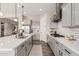 Bright kitchen featuring stainless steel appliances, gray cabinets, a large island, and tile backsplash at 10717 E Tarragon Ave, Mesa, AZ 85212