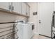 Functional laundry room featuring ample storage, washer, and dryer at 10717 E Tarragon Ave, Mesa, AZ 85212