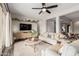 View of the living room featuring modern furniture, décor, ceiling fan, and view to the entrance at 10717 E Tarragon Ave, Mesa, AZ 85212