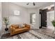 Cozy living room featuring modern decor, hardwood floors, and a comfortable leather sofa at 10717 E Tarragon Ave, Mesa, AZ 85212