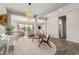 Open concept living room showcasing hardwood floors, a pendant light, and an indoor-outdoor flow at 10717 E Tarragon Ave, Mesa, AZ 85212