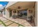 Inviting covered patio with dining area, ceiling fan, tv and comfortable seating at 10717 E Tarragon Ave, Mesa, AZ 85212