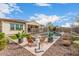 Inviting backyard featuring a fire pit and lounge area, protected by a pool safety fence and lush landscaping at 10717 E Tarragon Ave, Mesa, AZ 85212