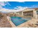 Serene backyard oasis featuring a sparkling pool enclosed by a safety fence, and a cozy seating area for relaxation at 10717 E Tarragon Ave, Mesa, AZ 85212