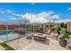 Backyard patio features a modern fire pit, lounge seating, and a safety fence surrounding the inviting pool at 10717 E Tarragon Ave, Mesa, AZ 85212