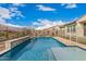 Backyard showcasing a fenced pool area with travertine decking, ideal for safe and stylish outdoor living at 10717 E Tarragon Ave, Mesa, AZ 85212