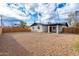 Spacious backyard showcasing a white brick home, gravel landscaping, and a wooden fence at 10947 W Mohave St, Avondale, AZ 85323