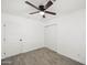 Bright bedroom with a ceiling fan, neutral walls, and two white doors at 10947 W Mohave St, Avondale, AZ 85323