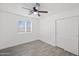 Light bedroom featuring a ceiling fan, a window, and a closet with sliding doors at 10947 W Mohave St, Avondale, AZ 85323