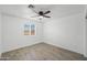 Bright bedroom featuring a ceiling fan, a window, and a closet with sliding doors at 10947 W Mohave St, Avondale, AZ 85323