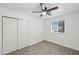 Light bedroom featuring a ceiling fan, window, and a closet with sliding doors at 10947 W Mohave St, Avondale, AZ 85323