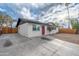 A large driveway leading to a well-kept white brick home with a striking red front door at 10947 W Mohave St, Avondale, AZ 85323