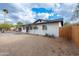 A well-maintained exterior view showcasing a white brick home with a manicured gravel yard at 10947 W Mohave St, Avondale, AZ 85323