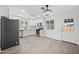 Modern kitchen featuring stainless steel appliances, white cabinetry, and stylish tiled floors at 10947 W Mohave St, Avondale, AZ 85323