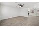 Spacious and naturally lit living room with gray wood-look floors and ceiling fan at 10947 W Mohave St, Avondale, AZ 85323