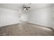 Bright open living room with gray wood-look flooring and a ceiling fan at 10947 W Mohave St, Avondale, AZ 85323