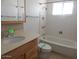 Bright bathroom with a shower over tub and vanity with storage at 11410 N 105Th Ave, Sun City, AZ 85351