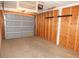 Attached garage with side wall mounted storage system and a light grey garage door at 11410 N 105Th Ave, Sun City, AZ 85351