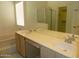 Bathroom featuring double sinks, a bathtub, and a separate shower at 12046 S 44Th St, Phoenix, AZ 85044