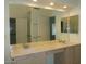 Well-lit bathroom featuring double sinks, large mirror, and vanity at 12046 S 44Th St, Phoenix, AZ 85044