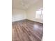 Spacious bedroom featuring wood-look flooring, a ceiling fan, and a window at 12046 S 44Th St, Phoenix, AZ 85044