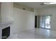 Bright and open living room with tile floors, fireplace, and sliding door access to outside at 12046 S 44Th St, Phoenix, AZ 85044