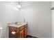 Half bathroom featuring wood cabinets, a single sink, and tile flooring at 1213 W Esplanade St, Mesa, AZ 85201