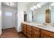 Bright bathroom featuring a double sink vanity and a door to the exterior at 1213 W Esplanade St, Mesa, AZ 85201