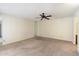 Neutral bedroom with ceiling fan, carpeting, and en-suite bath access at 1213 W Esplanade St, Mesa, AZ 85201