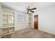 Bedroom with ceiling fan, built-in shelving, and carpeted floor at 1213 W Esplanade St, Mesa, AZ 85201